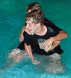 lifesaving friendly hug after pushing into pool